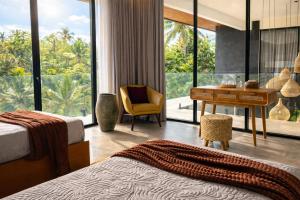 a room with two beds and a desk and a chair at Oran Villa Bali in Tampaksiring +46 photos