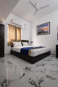 a bedroom with a bed in a room with marble floors at Hotel Rhythms Residency in Chennai +4 photos