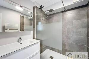 a bathroom with a sink and a shower at Le Panoramique Marin- 2Ch in Bray-Dunes