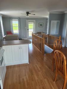 a living room with a kitchen and a dining room at Nice and cozy in Dalhousie