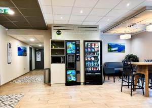 a soda machine in a restaurant with a table at B&B HOTEL Aix-les-Bains in Grésy-sur-Aix