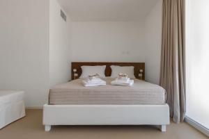 a bedroom with a bed with two towels on it at Agriturismo Agricola Chiani in Melendugno