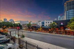 a city street with cars parked on the side of a road at 17th Ave Cozy Place in DT, short walk to Calgary Stampede in Calgary