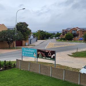a street with a sign on the side of a road at Dolfyn201 La Mer in Hartenbos