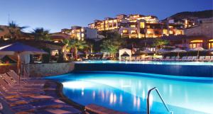 a swimming pool with chairs and a hotel at night at Pueblo Bonito Sunset Beach Owners Exec Suite 1BR2B REQUEST DATE see Clay & Lisa in Cabo San Lucas