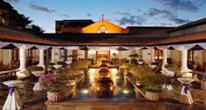 a building with a courtyard with potted plants and a church at Pueblo Bonito Sunset Beach Owners Exec Suite 1BR2B REQUEST DATE see Clay & Lisa in Cabo San Lucas