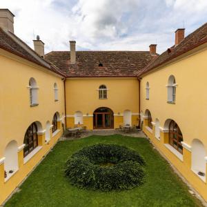 an exterior view of a building with a large yard at AndersOrt Haus der Frauen in Buchberg bei Herberstein