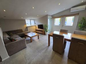 a living room with a couch and a table at Dorpsdijk 53A in Vrouwenpolder