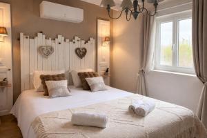 a bedroom with a large white bed with towels on it at Le Petit Nid de Beauval in Saint-Aignan