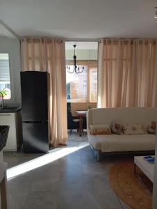 a living room with a couch and a table at Monplaisir in Fréjus