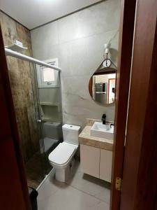 a bathroom with a toilet and a sink and a shower at Refúgio Rossa in Xangri-lá +15 photos