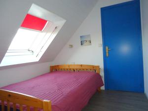 a bedroom with a bed and a blue door at Atlantik in Loperhet +22 photos