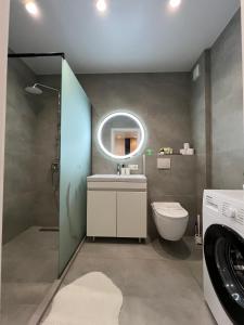 a bathroom with a sink and a toilet and a mirror at Cruds Arena Chisinau in Chişinău +15 photos