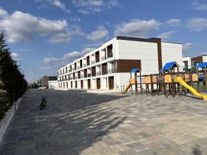 a playground in front of a building with a slide at Cruds Arena Chisinau in Chişinău