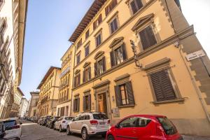 a row of cars parked in front of a building at Hotel Cimabue in Florence