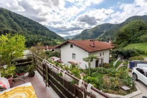 a house with a view of the mountains at Apartmaji Loretica in Most na Soči