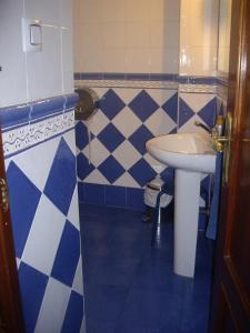 a blue and white bathroom with a sink and a toilet at Hostal Pacios in Madrid +28 photos