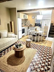 a living room with a couch and a table at La petite maison dans la bastide in Carcassonne