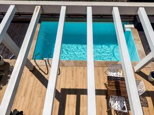 an overhead view of a swimming pool on a wooden deck at Seaside Pool Villas by BookVillaEU in Nea Kallikrateia