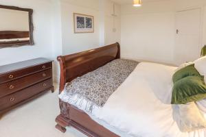 a bedroom with a bed and a dresser and a mirror at Host & Stay - Combpyne in Compton +23 photos