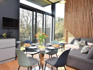 a living room with a table and chairs and a couch at 2 Bed in Brecon oc-59733 in Talgarth