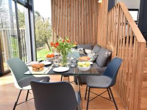 a table with food on it with chairs and a couch at 2 Bed in Brecon oc-59733 in Talgarth +25 photos