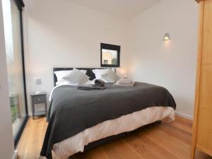 a bedroom with a bed with a cat laying on it at 2 Bed in Brecon oc-59733 in Talgarth