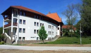 a large white building with a red roof at SDG Családi Hotel és Konferencia Központ in Balatonszárszó +10 photos