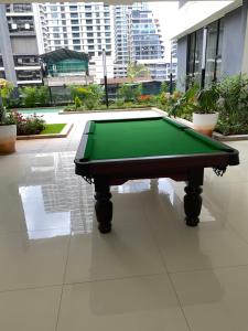 a green pool table sitting on top of a floor at Luxeliving Homes in Nairobi