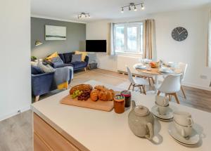a kitchen and living room with a table and a couch at 2 Bed in Woolacombe oc-beache in Woolacombe