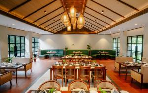 a large dining room with tables and chairs at Siddhartha Riverside Resort, Chumlingtar in Makaising