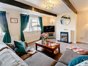 a living room with a couch and a table at 3 Bed in Holmfirth oc-91797 in Holmfirth