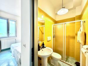 a bathroom with a sink and a shower and a toilet at Casa Appia - Authentic Beachfront House with Sea- View Garden in Santa Maria al Bagno - Marea Stays Collection in Nardò