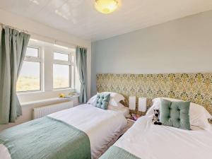a bedroom with two beds and a window at 3 Bed in Holmfirth oc-91797 in Holmfirth