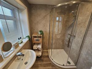 a bathroom with a shower and a sink at 3 Bed in Holmfirth oc-91797 in Holmfirth +13 photos