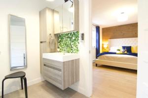 a bathroom with a sink and a bed in a room at Lakeside Getaway #5 Spa Sauna Firepit in Sainte Brigitte de Laval