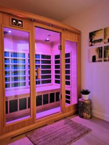 a room with purple lights on a glass door at Lakeside Getaway #5 Spa Sauna Firepit in Sainte Brigitte de Laval