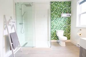 a bathroom with a shower and a toilet in it at Lakeside Getaway #5 Spa Sauna Firepit in Sainte Brigitte de Laval +41 photos