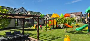 a park with a playground with at Domki Balos in Karwia