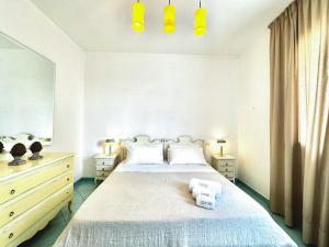 a bedroom with a bed with two towels on it at Casa Appia - Authentic Beachfront House with Sea- View Garden in Santa Maria al Bagno - Marea Stays Collection in Nardò