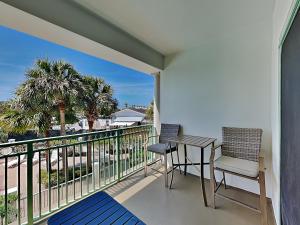 a balcony with two chairs and a table on it at Inn at Seacrest #203 - 30A Get-A-Way in Rosemary Beach