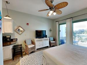 a bedroom with a bed and a flat screen tv at Inn at Seacrest #203 - 30A Get-A-Way in Rosemary Beach