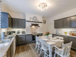 a kitchen with a table and chairs in a kitchen at 4 Bed in Holmfirth oc-86032 in Holmfirth