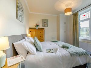 a bedroom with a white bed and a window at 4 Bed in Holmfirth oc-86032 in Holmfirth