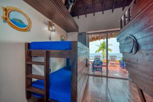a bunk bed in a room with a view of the ocean at Caribe Tesoro in West Bay +174 photos