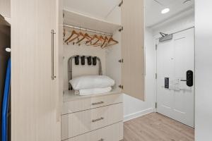 a walk in closet with wooden cabinets and a door at Placemakr Dupont Circle in Washington, D.C. +288 photos
