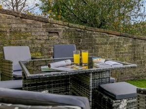 a table with two glasses of juice on a brick wall at 4 Bed in Holmfirth oc-86032 in Holmfirth +11 photos