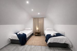 a bedroom with two beds and a lamp in it at 6 On Santorini in Langebaan