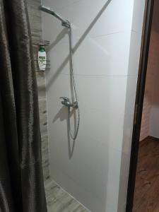 a shower in a bathroom with a glass door at Via Room in Raszyn