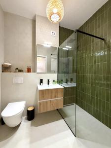 a bathroom with a toilet and a sink and a shower at Forestis Thermalis in Baile Felix